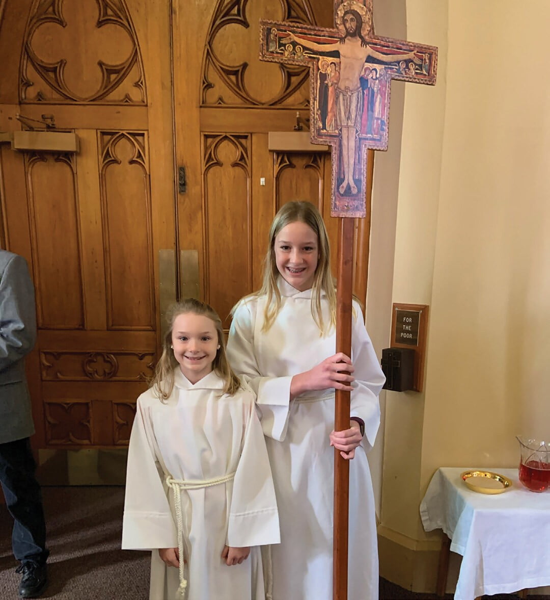 Altar server Allie Vranjes with her younger sister, Mia