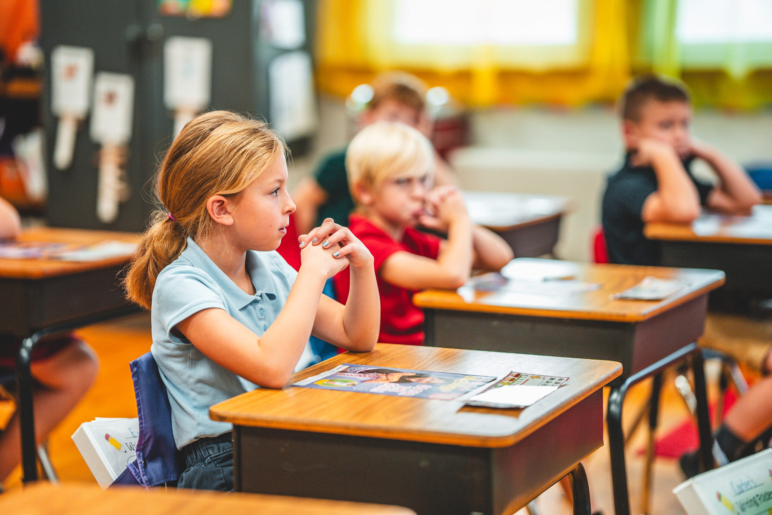 St. Francis Solanus students at their desks in a sunny classroom
