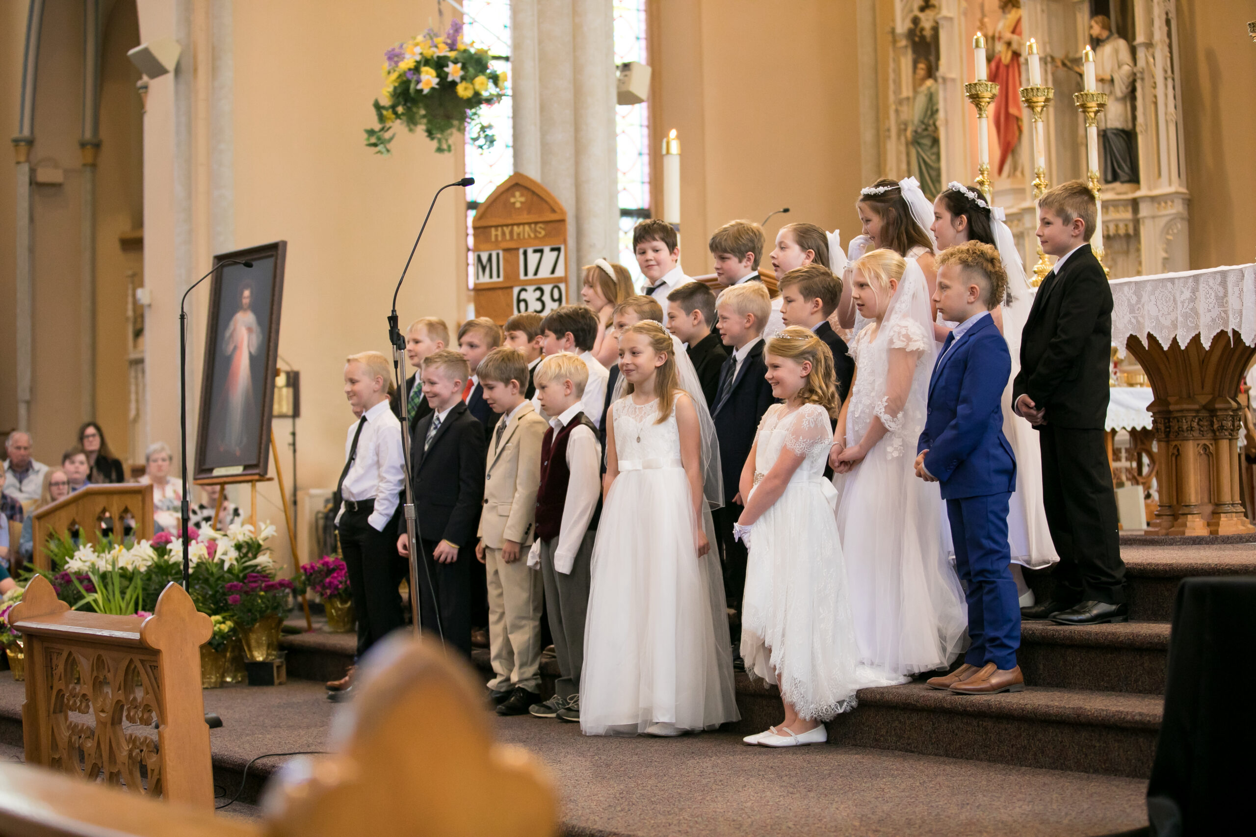 Children in their First Communion clothes at the front of St. Francis Solanus Church