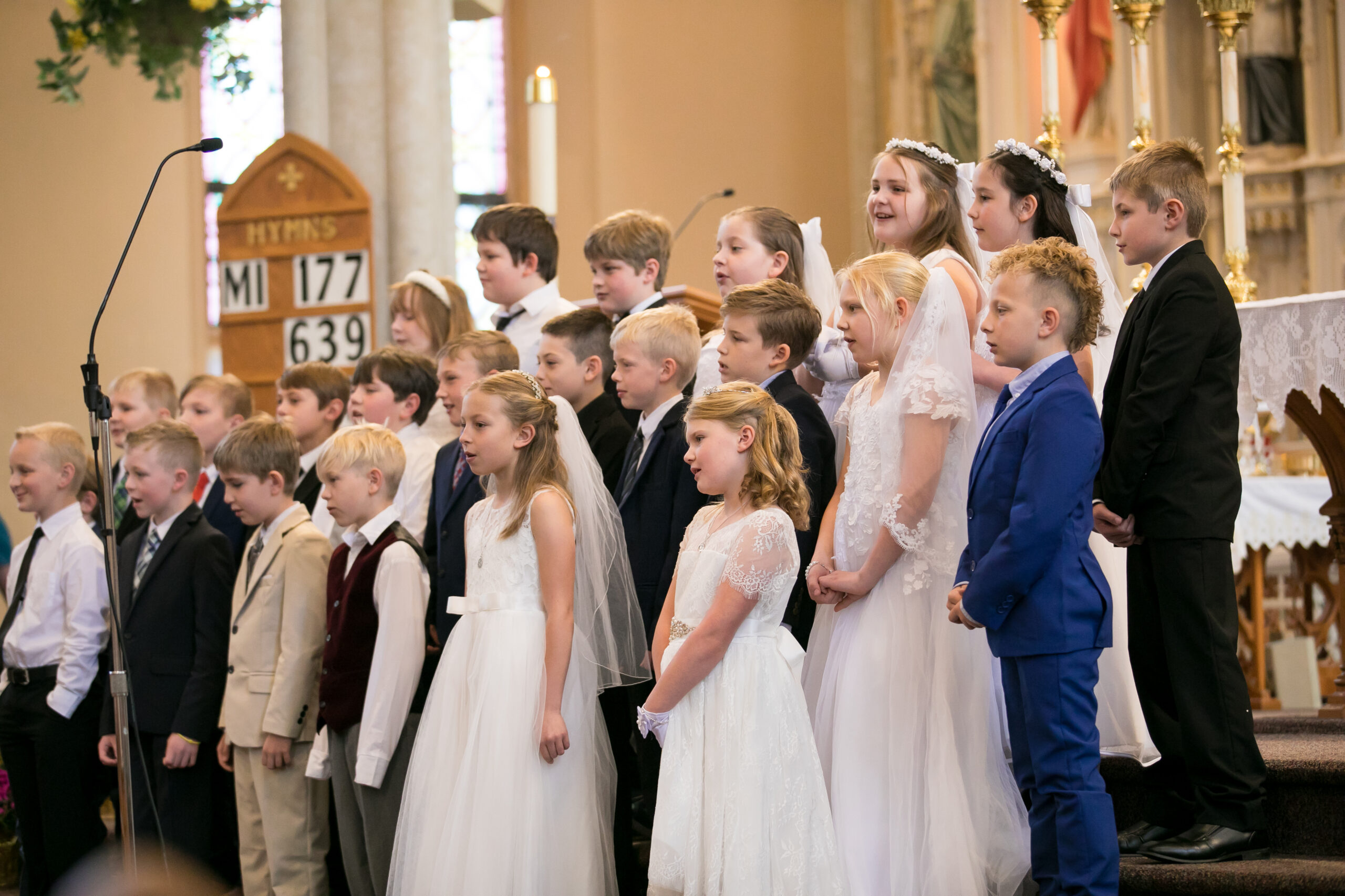 Children in their First Communion clothes at the front of St. Francis Solanus Church