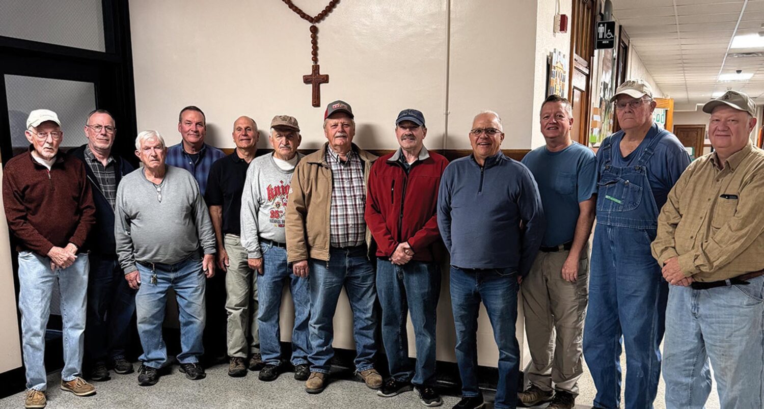 Members of the St. Francis Solanus men's group standing together in the parish hall