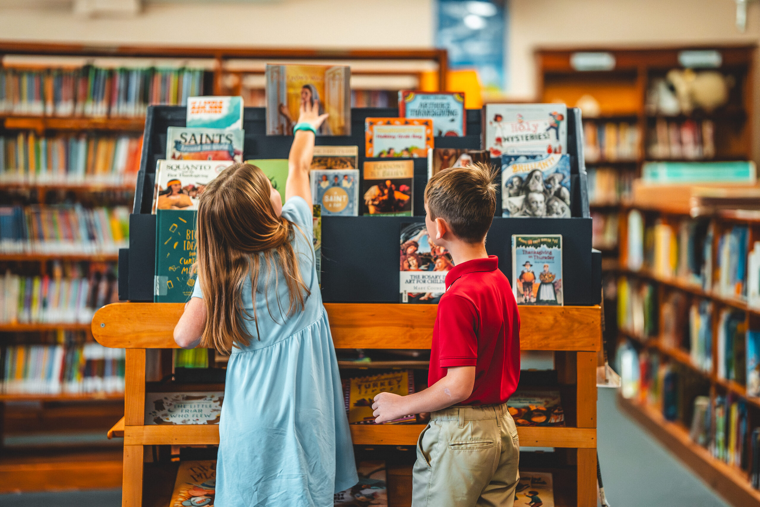 Students choosing books in the St. Francis library