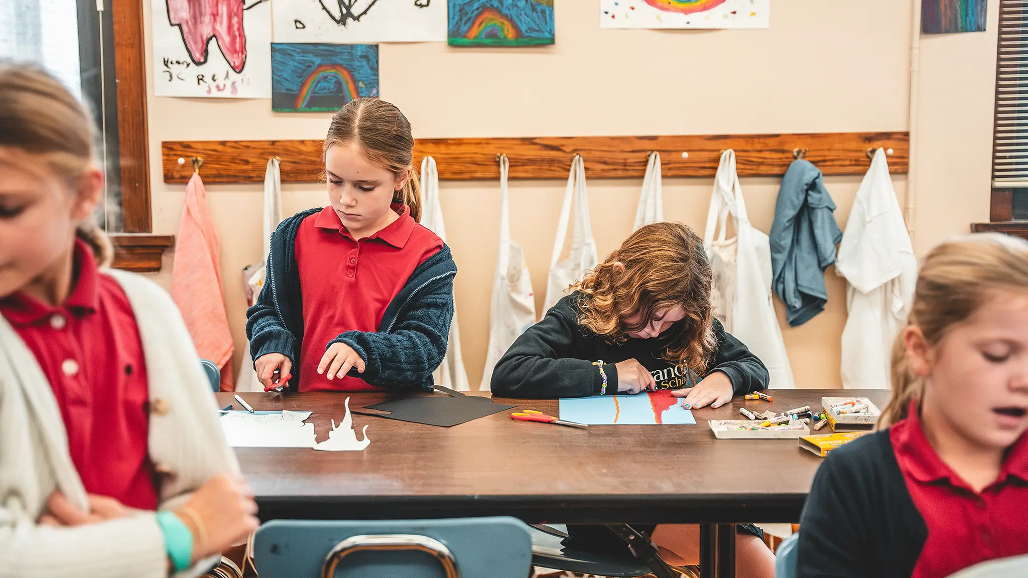 St. Francis students working on art projects at a classroom table