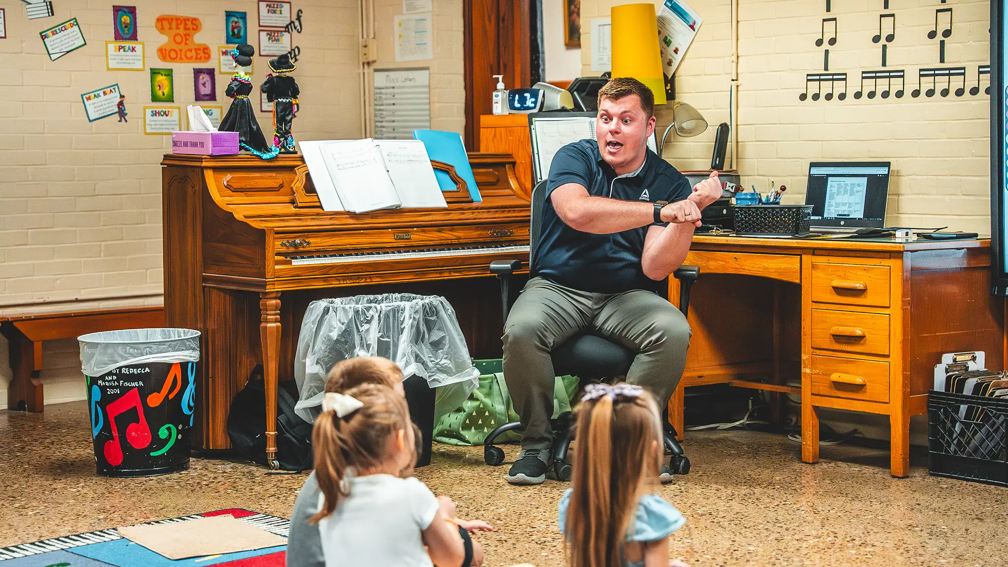 Mr. Crowl leading young students in music class