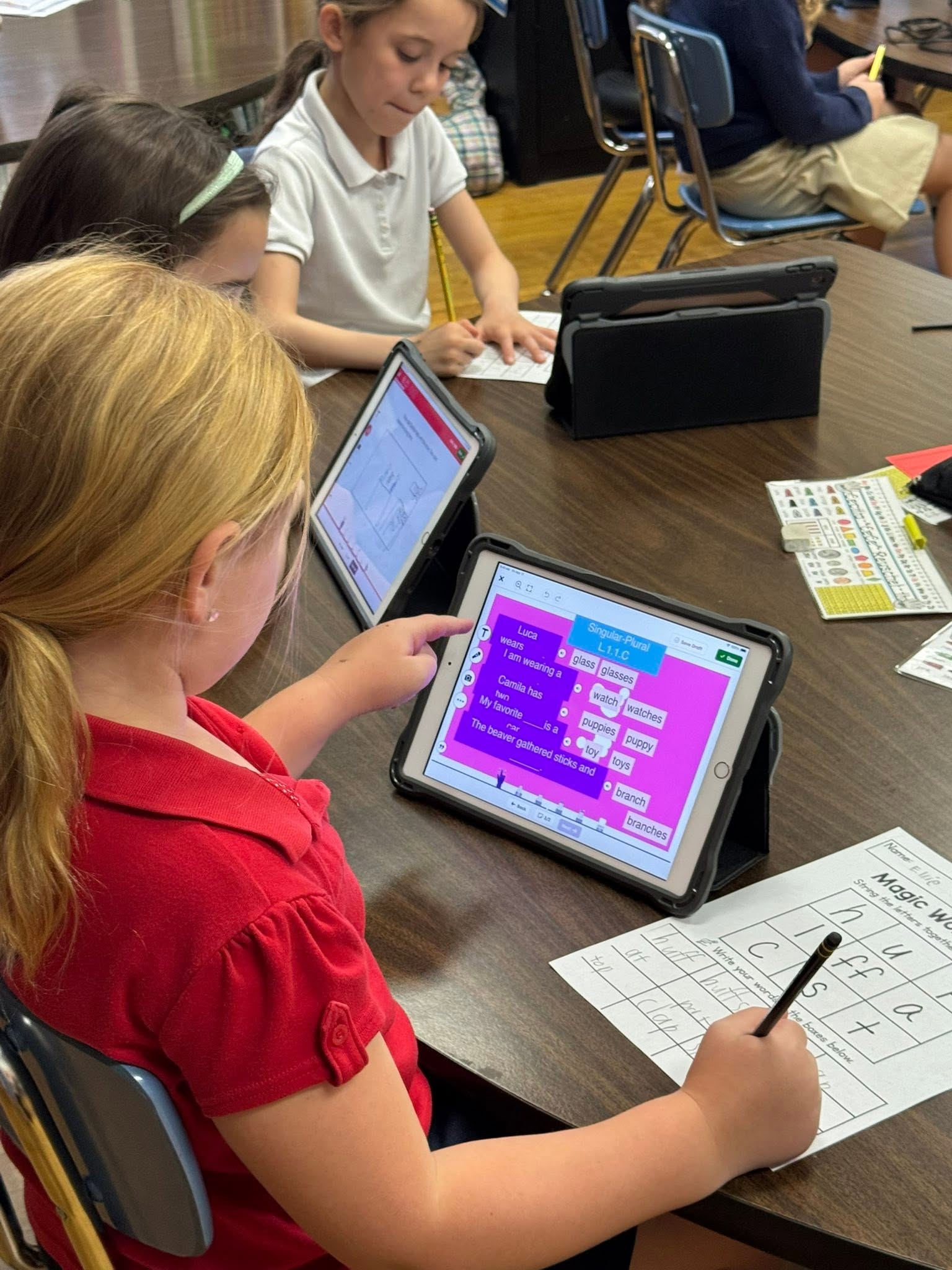 A St. Francis student working on a coding lesson on a tablet at her desk