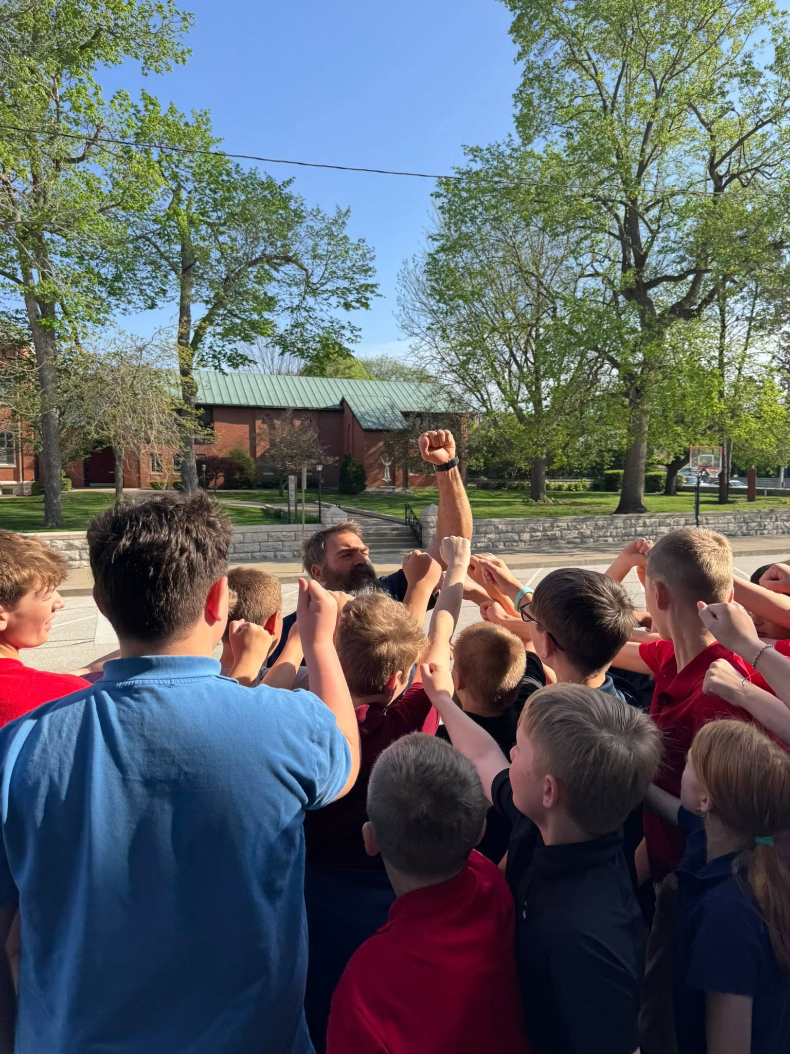 St. Francis students gathered in a cheering huddle outside the school
