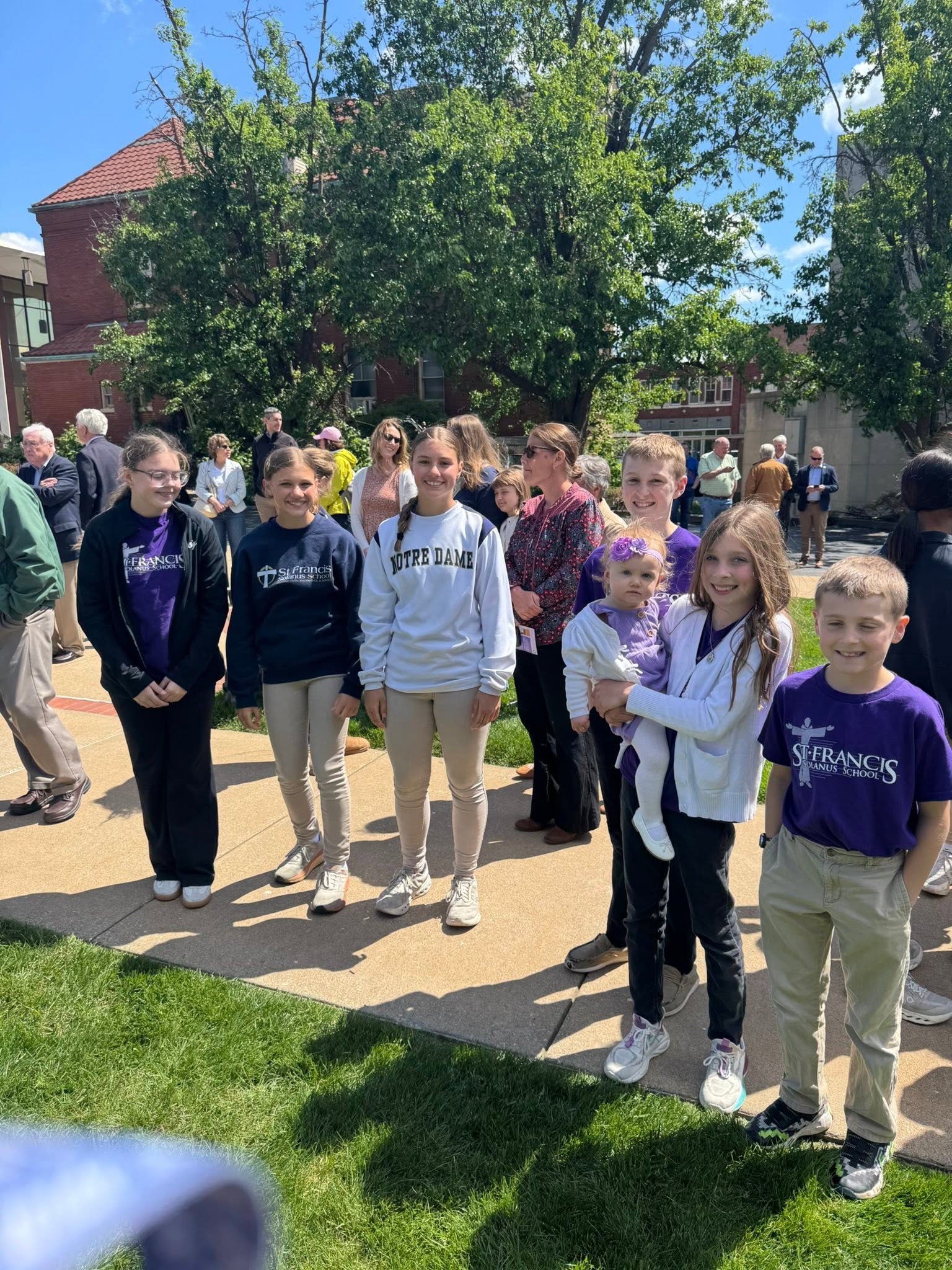 St. Francis students and families gathered outside, one student wearing a Notre Dame sweatshirt